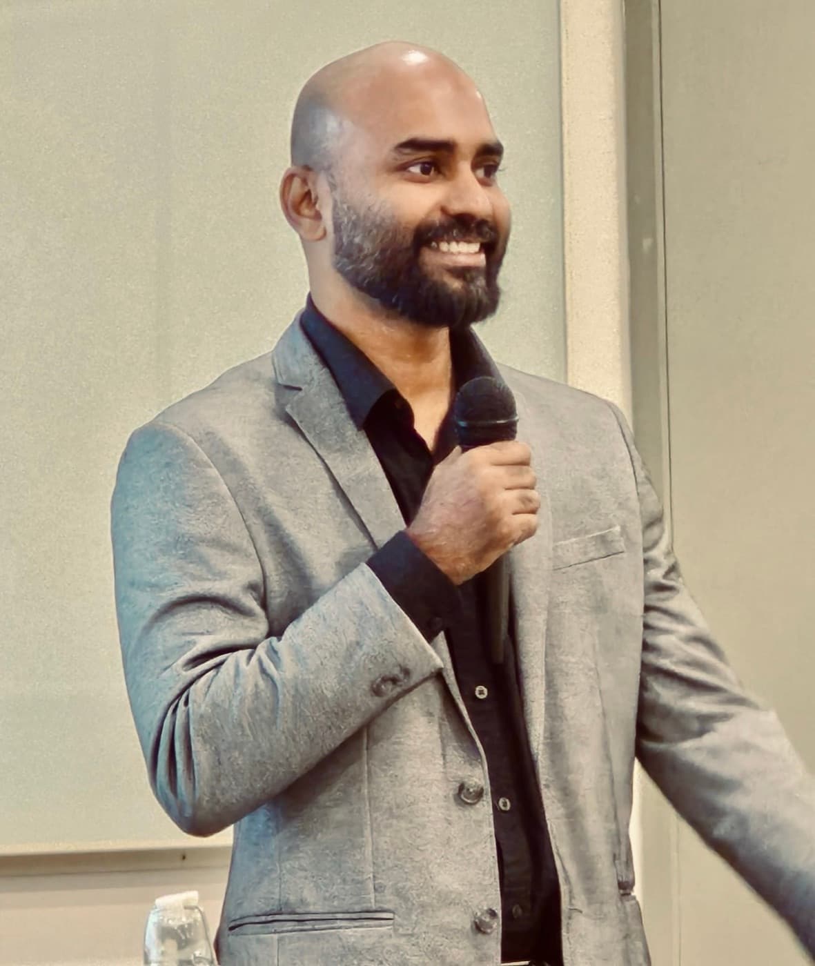 Praveen VR speaking to a room of engineers